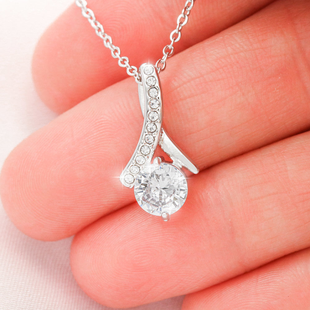 Alluring Beauty Necklace for Daughter – 14k White Gold or 18k Yellow Gold Plated meaningful gift held in hand.