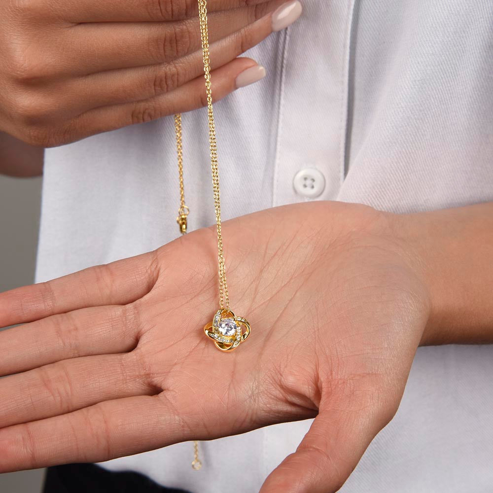 Love Knot Necklace for Grandma – A Meaningful Gift for Grandma | 14K White Gold or 18K Yellow Gold Plated held in hand showing delicate chain and pendant
