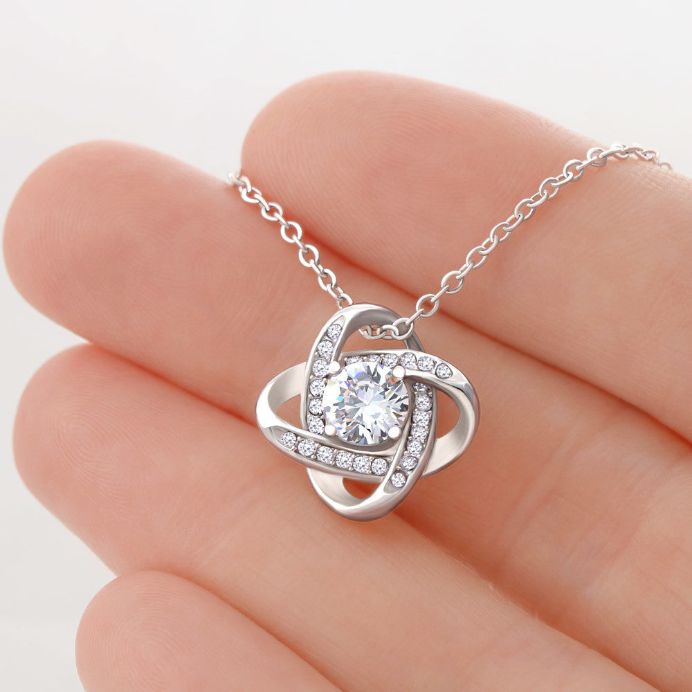 Love Knot Necklace for Bride –  A Meaningful Gift for the Bride | 14k White Gold or 18k Yellow Gold Plated held in hand showing intricate design