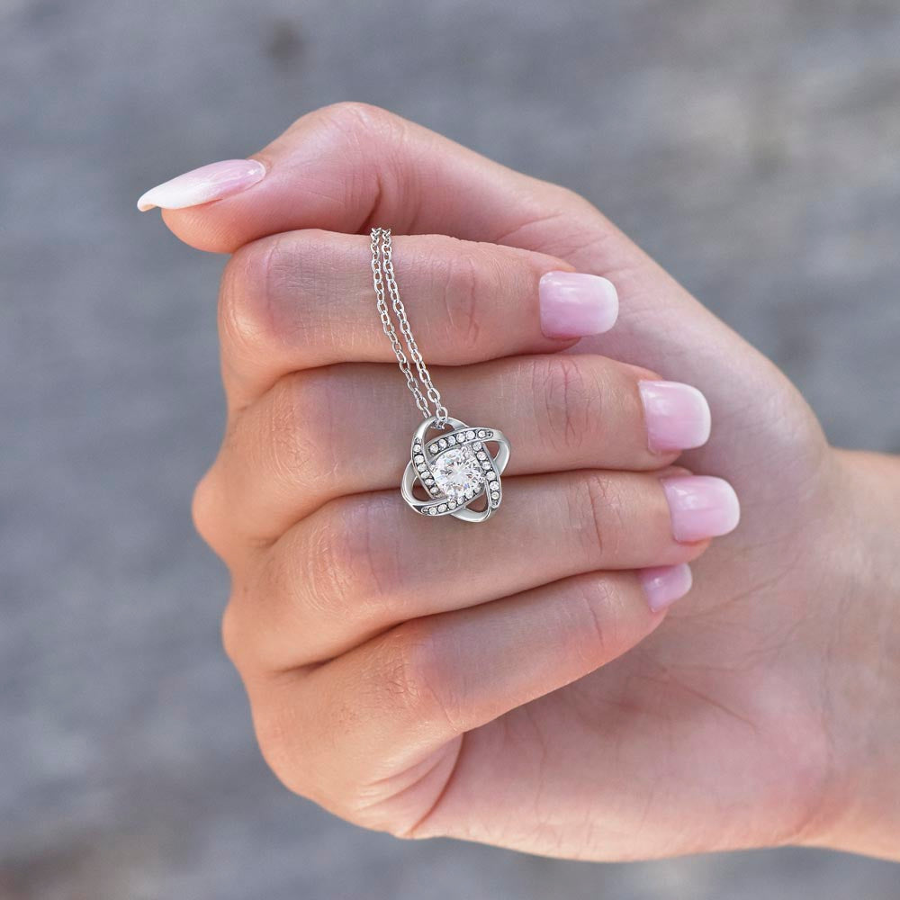 Love Knot Necklace for Grandma – A Meaningful Gift for Grandma | 14K White Gold or 18K Yellow Gold Plated held delicately in hand