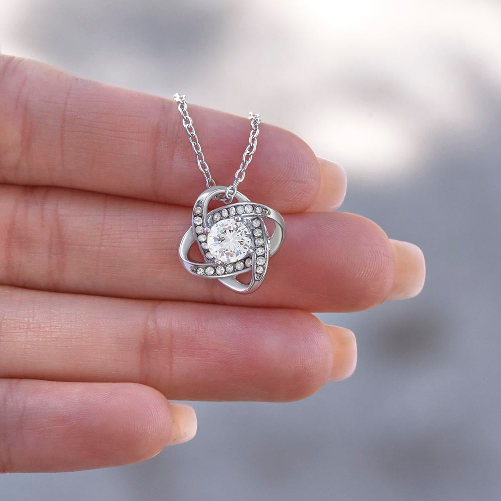 Love Knot Necklace for Grandma-To-Be – A Meaningful Baby Announcement Gift for Grandma | 14K White Gold or 18K Yellow Gold Plated held between fingers