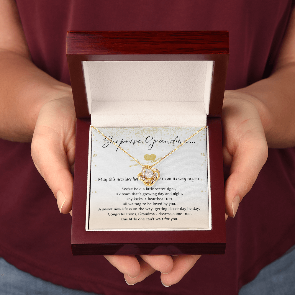 Love Knot Necklace for Grandma-To-Be – A Meaningful Baby Announcement Gift for Grandma | 14K White Gold or 18K Yellow Gold Plated in gift box held between hands