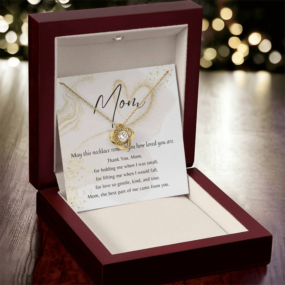 Love Knot Necklace in gold with cubic zirconia displayed in a mahogany gift box and a heartfelt poem card for Mom.