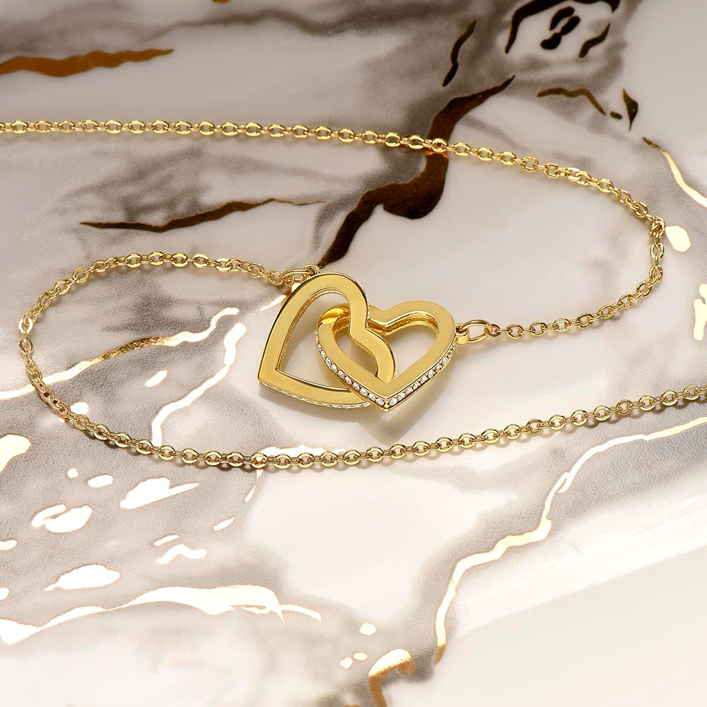 Interlocking Hearts Necklace for Grandma – A Meaningful Gift for Grandma | Rose Gold or 18K Yellow Gold Plated with delicate crystal detail on marble surface