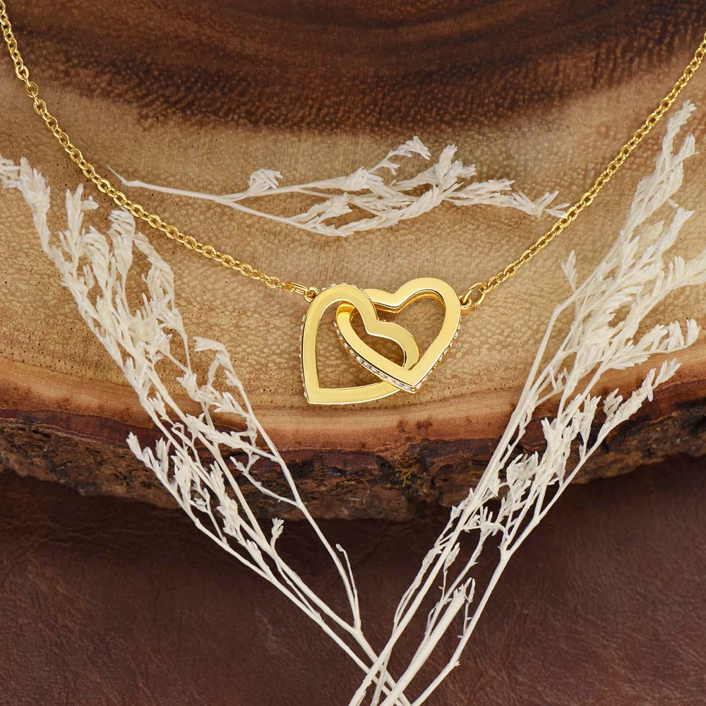 Interlocking Hearts Necklace for Maid of Honor – A Meaningful Maid of Honor Proposal Gift | Rose Gold or 18K Yellow Gold Plated displayed with delicate dried flowers