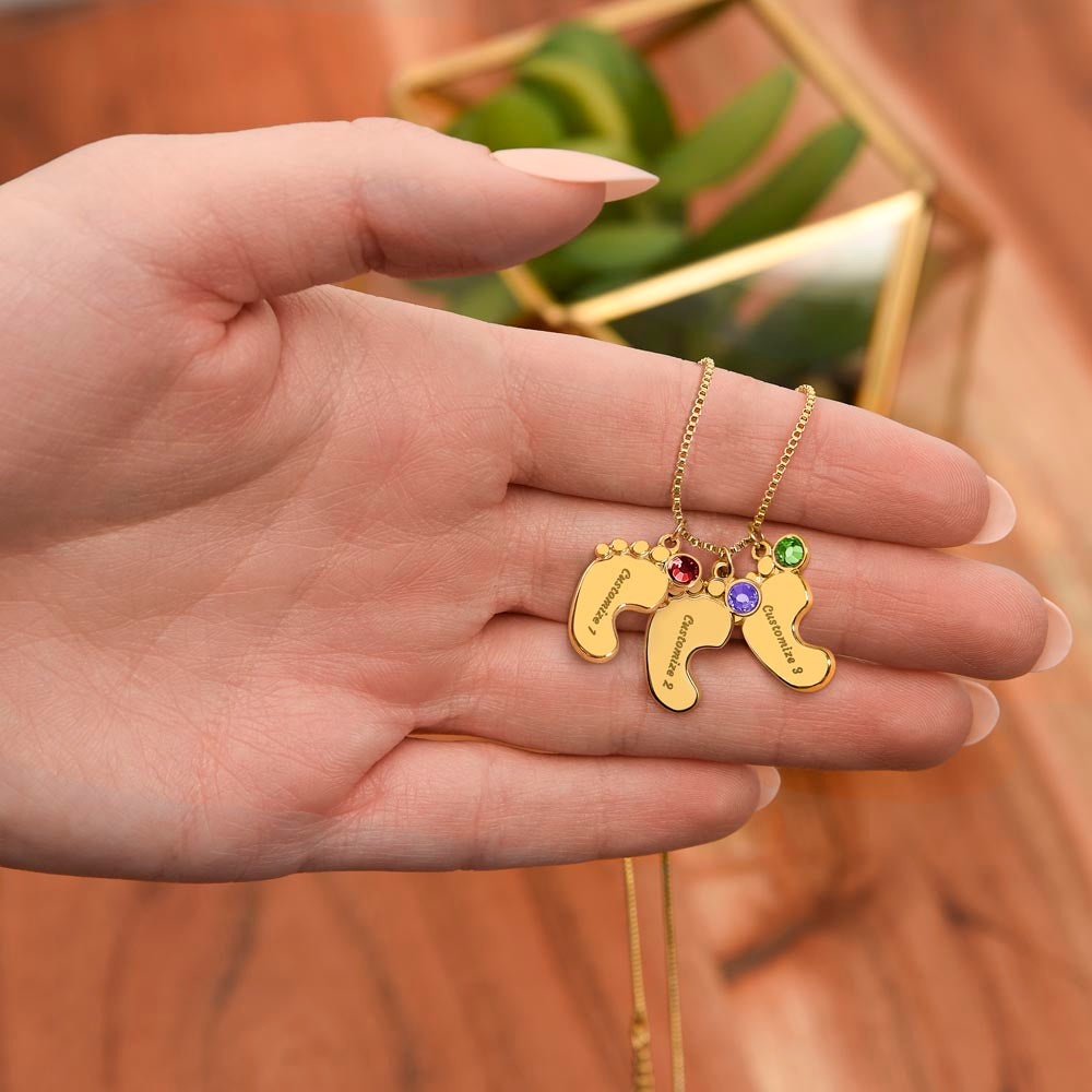 Personalized Engraved Baby Feet Necklace with Birthstone for Grandma (2-4 Charms) – meaningful jewelry in gold finish shown in hand