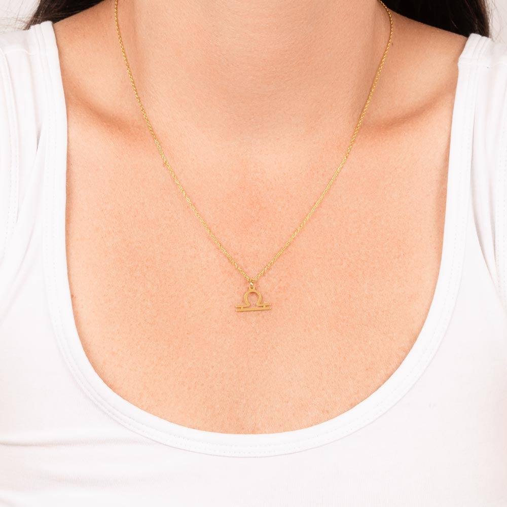 Libra Zodiac Necklace for Women – Astrology Gift with delicate gold pendant on fine chain worn over white scoop neck top