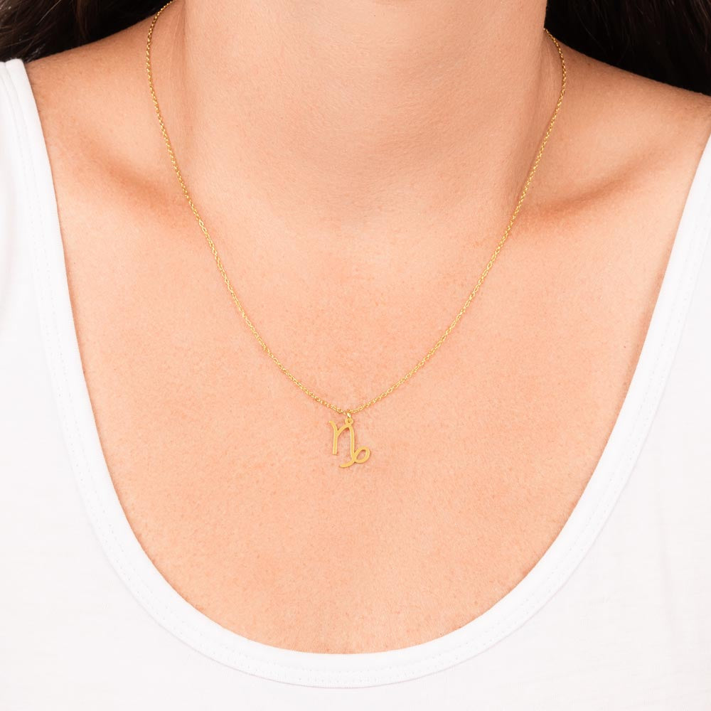 Capricorn Zodiac Necklace for Women – Astrology Gift with gold pendant on delicate chain worn with white scoop neck top